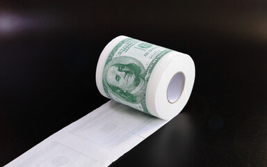Roll of toilet paper in form of dollars, concept of deficit and inflation, on black background with...