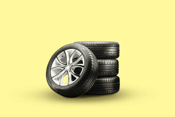 summer tires and wheels-stack on a yellow background, new wheels
