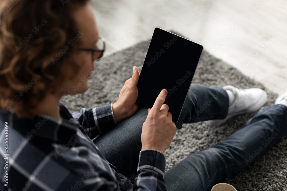 Poster Man Using Digital Tablet With Blank Screen Indoor, Back View