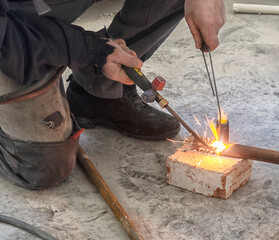 worker cutting steel pipe using metal torch