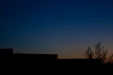 Naklejka na ściany i meble silhouette of the fence against the evening sky. Free copy space