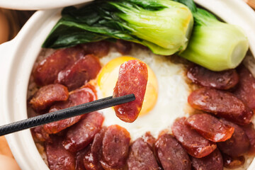 Cantonese style cooking of claypot rice with waxed meats