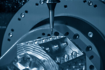 The  5-axis machining center cutting the v8-engine cylinder block. The 5-axis milling machine cutting the aluminum cylinder block manufacturing process. © Pixel_B