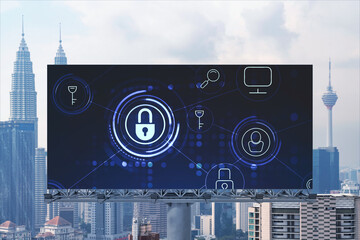 Padlock icon hologram on road billboard over panorama city view of Kuala Lumpur at day time to protect business, Malaysia, Asia. The concept of information security shields.