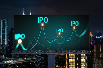 IPO icon hologram on road billboard over night panorama city view of Kuala Lumpur. KL is the hub of...