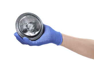 Hand in blue glove holding car fog headlight, isolated on white background. Automotive parts.