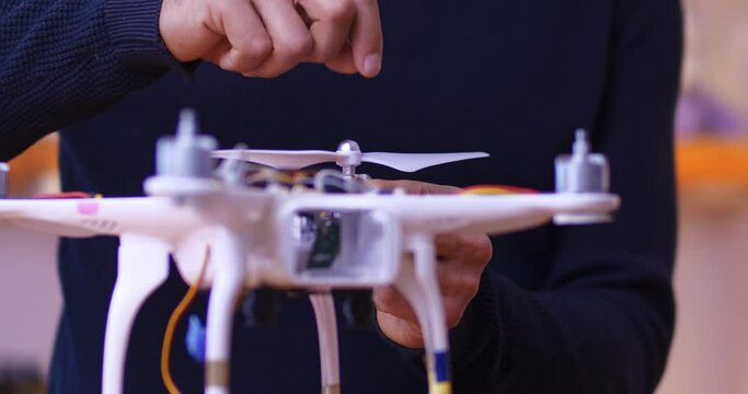 Male hands mount the propeller on the drone. The concept of creating and implementing individual business ideas