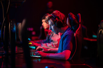 Professional esports players at an online game tournament. The cyber team plays computers and trains