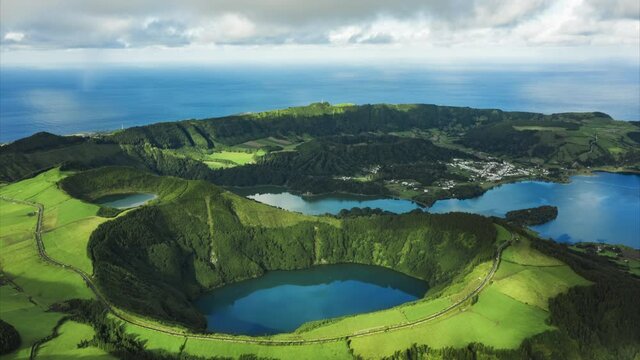 Cinematic hyperlapse blue lakes on green peaks, tropical island nature. Aerial hyper lapse twin lake Lagoa das Sete Cidades in the volcano crater. Ponta Delgada on Sao Miguel Island, Azores, Portugal