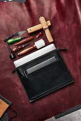 Set of handmade leather goods, key holder rings, wallet, purse, notepad, handbook. Handcrafted leather goods, close-up