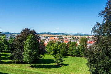 Fototapeta na wymiar Landscape view near Boskovice castle ruins in Czech Republic. Blue sky, meadow, trees, red roofs of houses