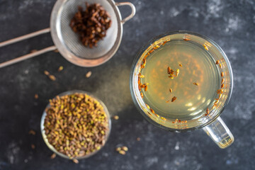 Hot healthy tea with fresh birch buds in spring, close up, top view