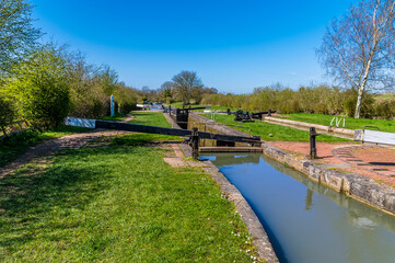 Fototapeta na wymiar A view down the Oxford Canal towards Hillmorton Locks, Warwickshire, UK on a bright Spring day