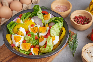 Diet menu. Healthy salad of fresh vegetables - tomatoes, egg, Onion. high angle view of a nutritious vegetable salad with boiled egg slices, served.  Healthy meal concept.