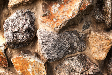 Wall of gray and red old stones, masonry texture