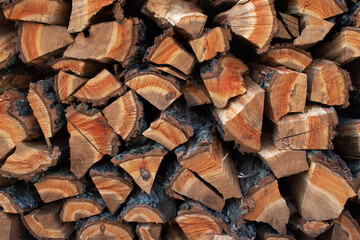 stack of chopped firewood in a woodpile