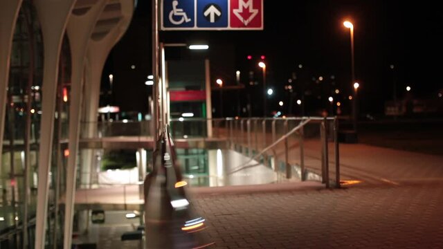 Traffic sign for disabled people. Empty bus station at night. Focus movement from bokeh.