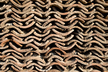 Wall of old brown roof tiles