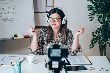 Teacher recording video tutorial for e-learning class.
Female professor working from home teaching...