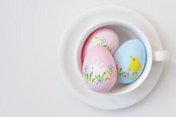 easter colored eggs with flowers on white background copy space