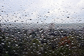 Beautiful rain drops on the window with nature outside