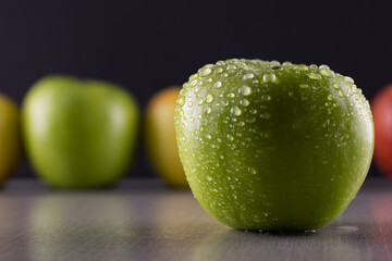 Water drops on a fresh green apple. Close-up.