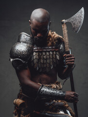 Evil manly warrior wearing royal antique armor and wielding an axe