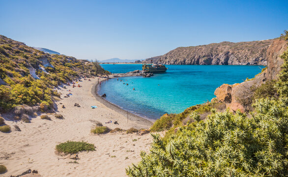 Ship with tourists on beautiful sandy beach Gyali. Boat trip. Volcanic island with turquoise water in the Dodecanese, between Kos and Nisyros, Greece