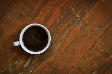 Brewed coffee cup on brown background