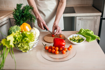 male hands chopping salad and onion, cooking healthy food in the kitchen.