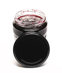 Blackcurrant jam in glass jar with lid, marmalade isolated on white background, top view