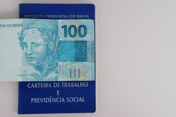 Brazilian work card (carteira de trabalho) and Brazilian money. Formal job concept. 
