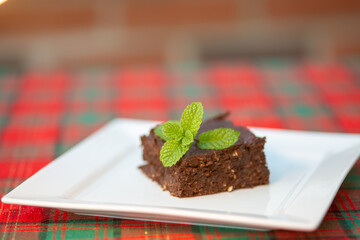 Slice of brownies on white plate