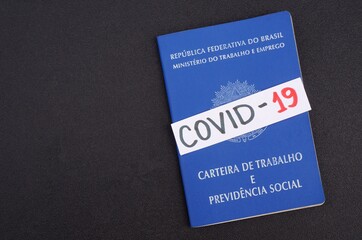 Brazilian Work Card (carteira de trabalho) and Covid-19 inscription. Coronavirus pandemic in Brazil concept.