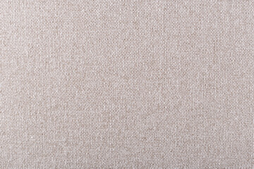 Fototapeta na wymiar smooth surface of dense cream-colored upholstery fabric with linen texture, background