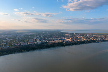 Aerial view of Galati City, Romania. Danube River near city with sunset warm light