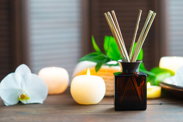 Spa background. Towel, candles, aroma sticks, orchid flowers and herbal balls. Massage, oriental therapy, wellbeing and meditation.