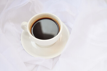 cup of coffee with white roses in the morning