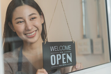 Smiling young asian business owner, employee retail,coffee shop woman,girl turning,setting sign...