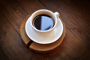 Brewed coffee cup on brown background