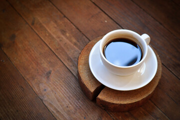 Brewed coffee cup on brown background