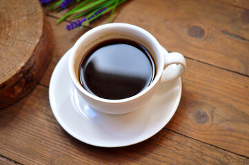 Fototapeta premium Brewed coffee cup on brown background