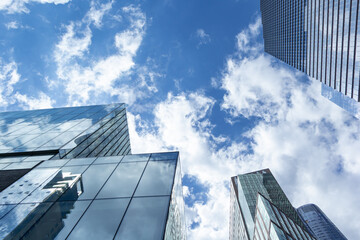 glass buildings by clear blue skies