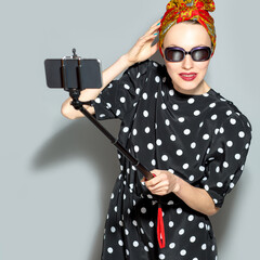 Self portrait of beautiful young woman weaing headscarf and sunglasses