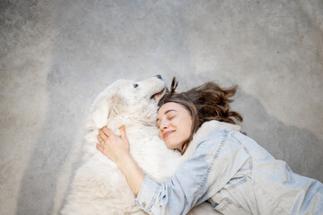 Woman with her dog lying together