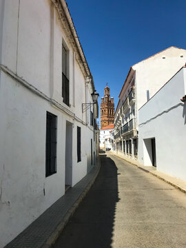 views of the tower of the church of Llerena from one of its streets