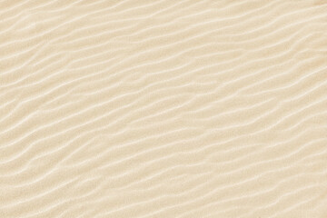 Abstract background. Diagonal sand stripes texture made by sea waves on beach.