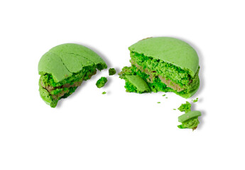 green macaron cake broken isolated on white background. leftovers. macaron crumbs