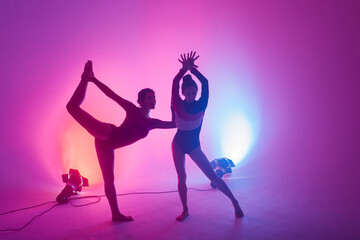 The two modern ballet dancers in black and red bodysuit, studio