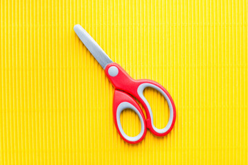 stationery scissors on yellow background, stationery scissors with red handle 